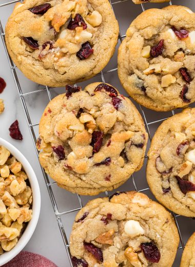 We love everything about these cookies, the amazing combination of cranberries, walnuts, and white chocolate, they have the perfect texture and thickness. These disappear quickly every time we make them. Here they are pictured close together cooling on a cooling rack.
