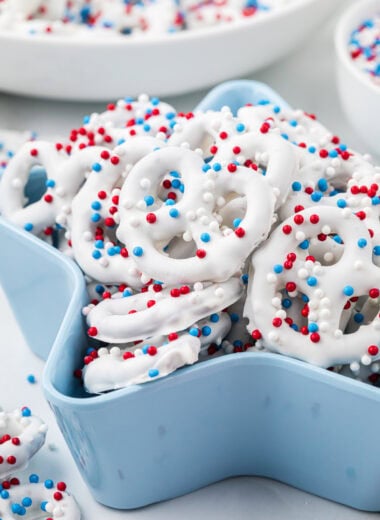 This image has the pretzels in a star-shaped serving container with additional pretzels in the foreground and background.