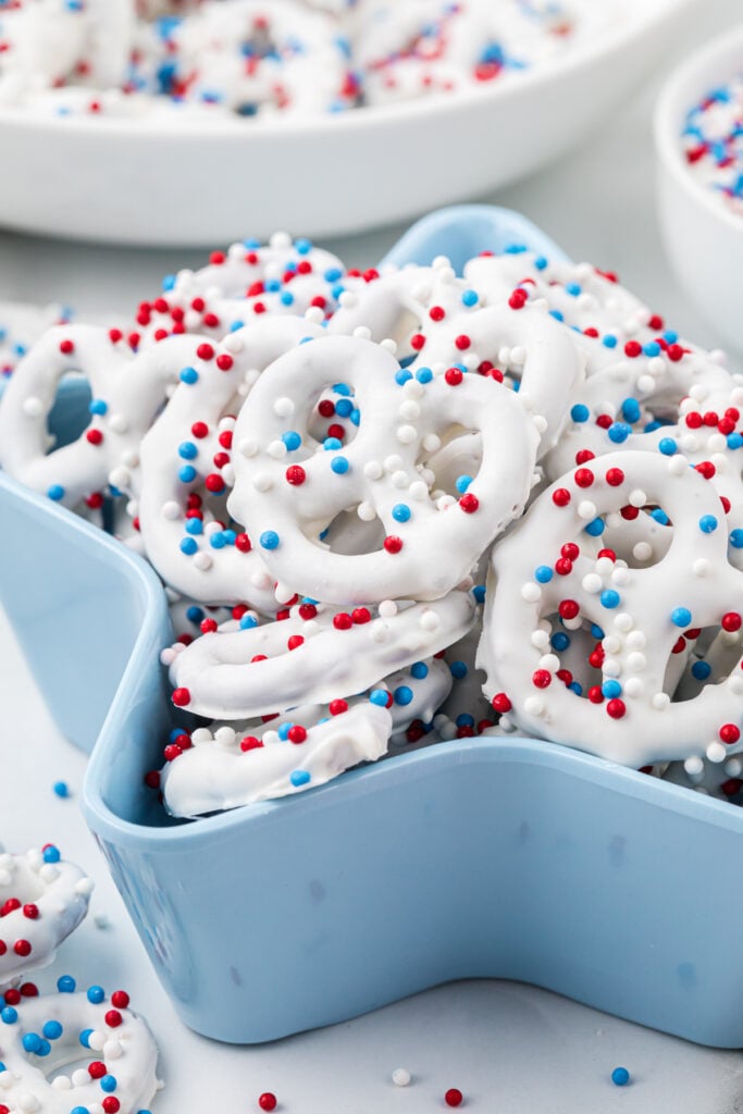 This image has the pretzels in a star-shaped serving container with additional pretzels in the foreground and background.