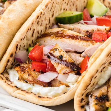 This image has the pitas ready to eat on a rectangular serving platter in the center of the image.