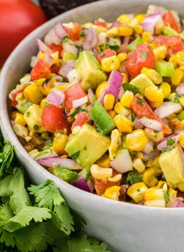 In this image, the salsa is mixed and ready to serve in a serving bowl in the center of the image.
