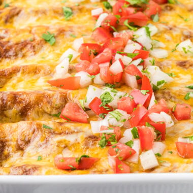 This image shows the enchiladas, just out of the oven topped with pico de gallo, ready to serve.